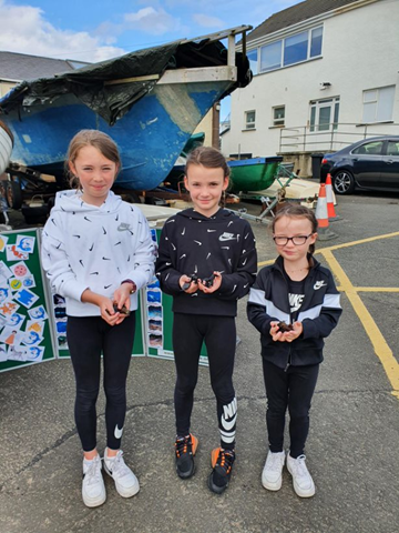 Three new shark and skate conservationists, with small-spotted catshark and spotted ray egg cases that they found at Portballintrae!